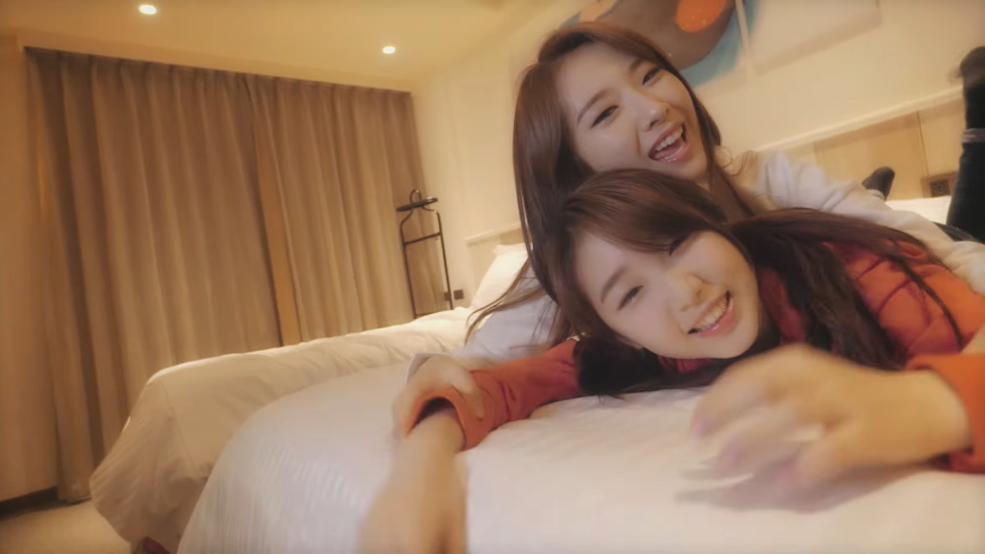 Haseul and Yeojin laying on a bed.